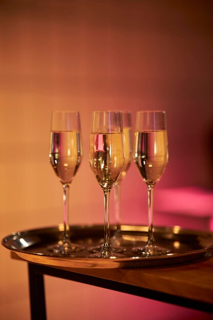 A tray with glasses of cold champagne with blurred background