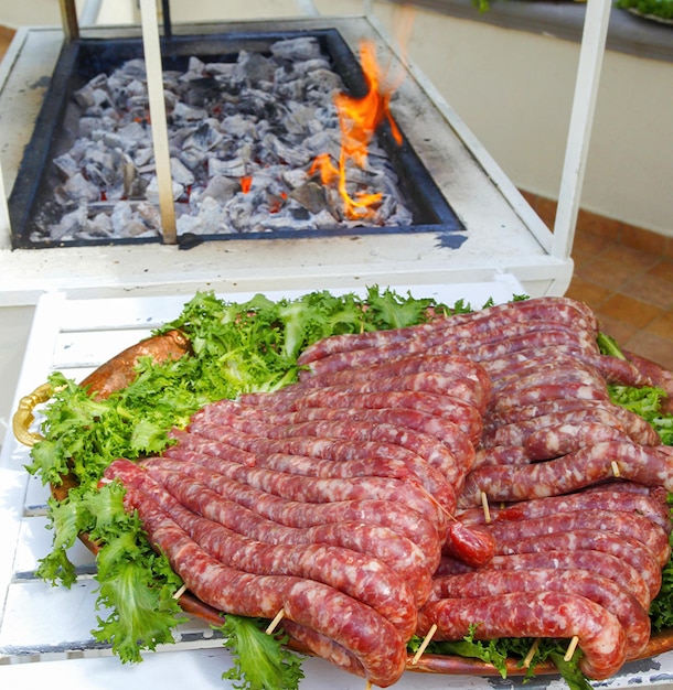 Tray with sausages ready to be cooked on the grill