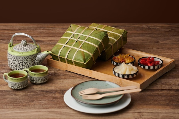 Tray with sticky rice cakes, pickled vegetables and tea for Spring festival celebration