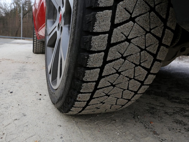 Tread blocks of cars winter tires covered by sand