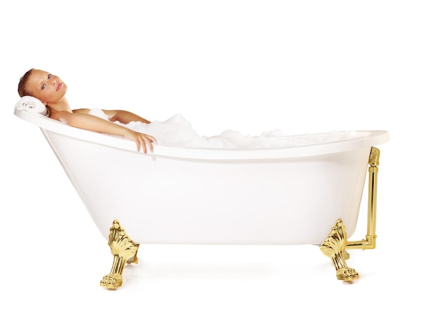 Treating herself to a relaxing foam bath Pretty young woman relaxing in a bath tub