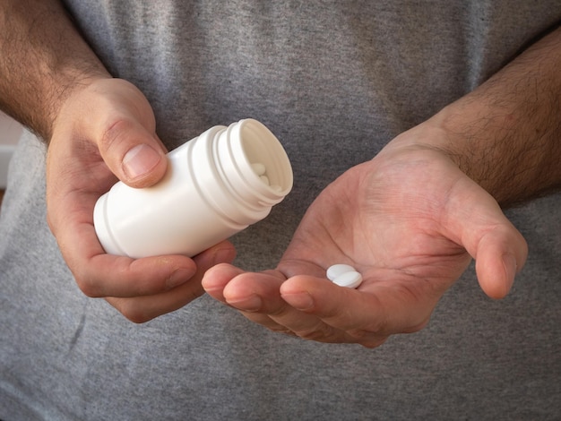 Treatment and prevention of diseases, a jar of medicine in men's hands.