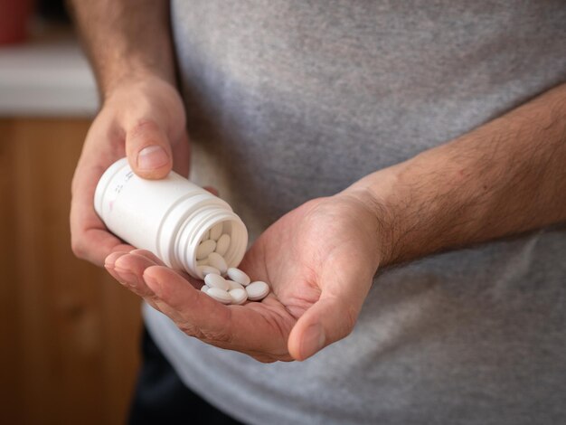 Treatment and prevention of diseases, a jar of medicine in men's hands.