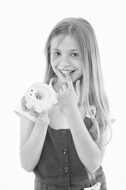 Treats for holidays Kid rewarded for good behavior with sugary treats Girl cute smiling face holds sweet donut Girl likes sweets as donuts How tame childs sweet tooth Treats and dieting concept