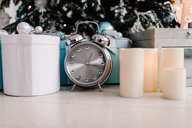 Photo tree with gifts boxes, clock, candles