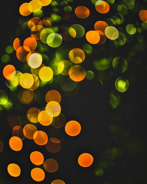 a tree with green and orange lights in the background