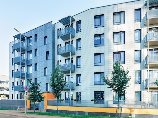 Trees near Complex of new apartment residential building with outdoor facilities.