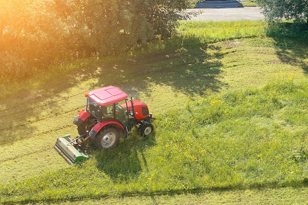 Trekker maait het gras in de tuin van het huis