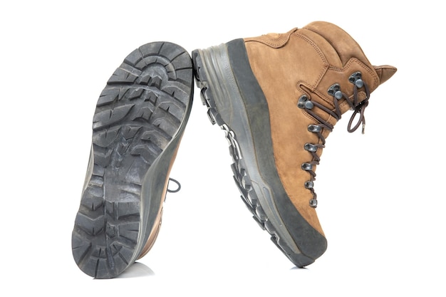 Trekking boots for hiking on a white background Equipment for travel and hiking