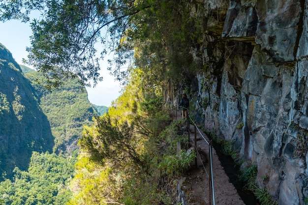 Trekking path next to the waterfall in the Levada do Caldeirao Verde Queimadas Madeira