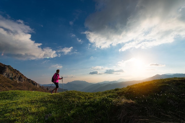 Trekking at sunset in the mountains alone