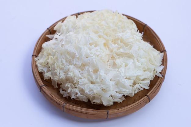 Tremella Mushroom in bamboo basket on white background.