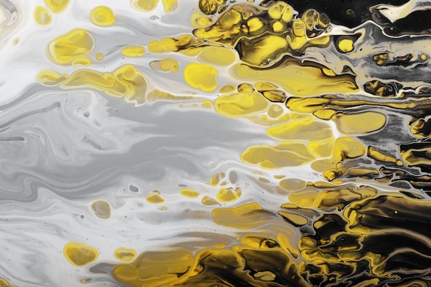 Trending colors of 2021. Horizontal Flow of gray paint with yellow bubbles drops. Marble effect background or texture. Fluid Art.