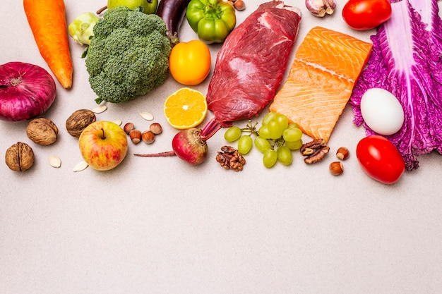 流行の古食/ペガン食。健康的なバランスのとれた食品のコンセプト。生鮮食品、生肉、サーモン、野菜、果物のセット