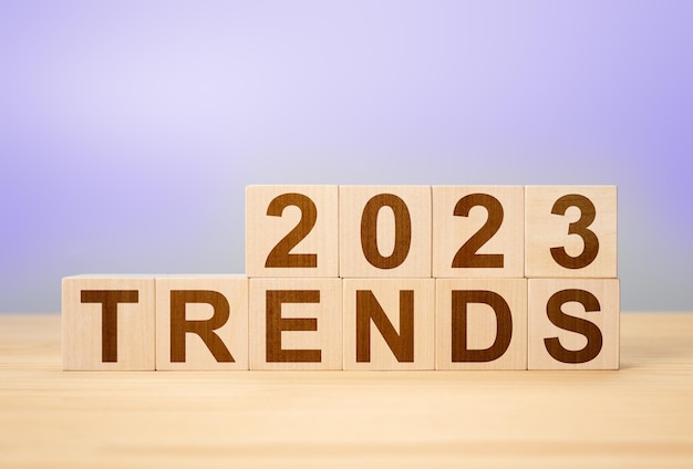 Trends 2022 word alphabet letters on wooden cubes, very peri color background. 2023 trends new year concept