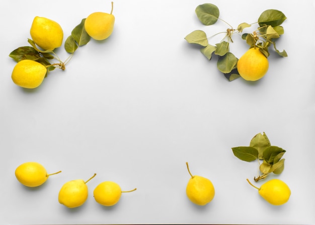 Trendy 2021 year ultimate gray and illuminating colors. frame composition of ripe yellow pears with leaves on a grey