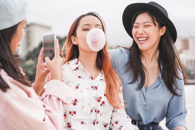 Trendy asian girls making video story for social network app outdoor