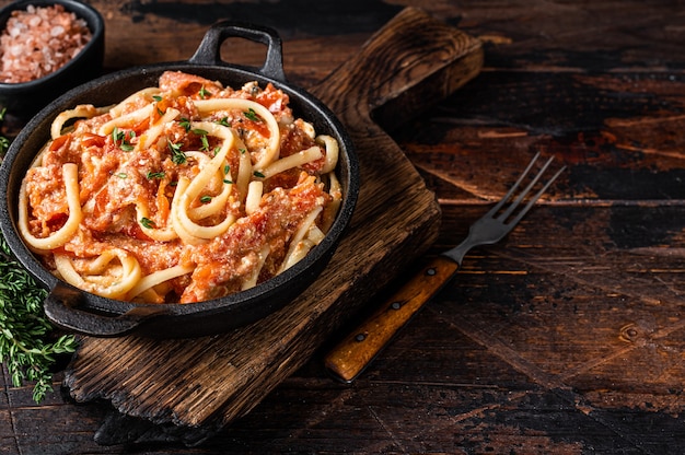 Trendy baked Feta pasta with Oven roasted tomatoes and cheese in a pan.