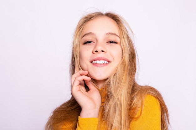 Trendy beautiful hipster girl. Photo of positive young nice woman in yellow knee-high with white background. looking at the camera and smiling