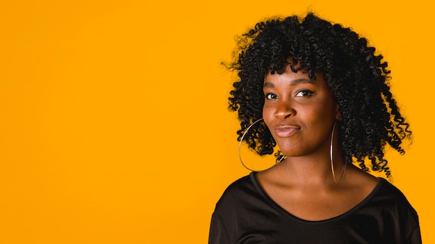 Trendy black young female on colored background