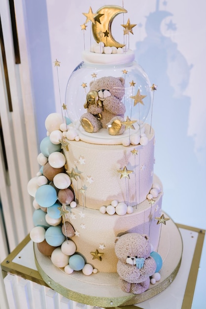 Trendy Cake with a figure bear moon and stars for a boy or girl Tiered cake decorated gold decor Baby shower Celebration baptism concept Delicious reception at a birthday party