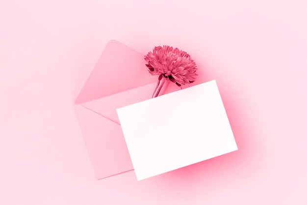 Trendy color of the year 2023 Blank card envelope and flowers toned in viva magenda color Top view Flat lay Mockup