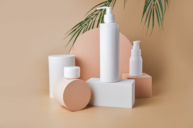 Photo trendy cosmetics tube and jar on pedestal at the beige surface