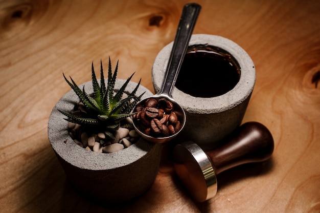 Trendy and cute concrete pots with coffee drink and plant