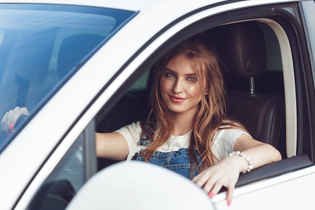 Trendy girl traveling by car