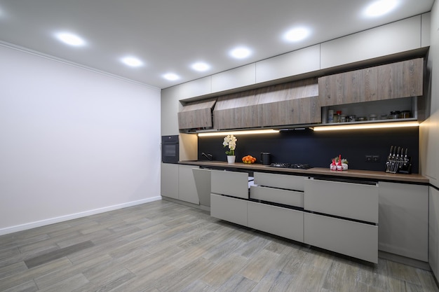Trendy grey modern kitchen interior with minimalistic furniture
