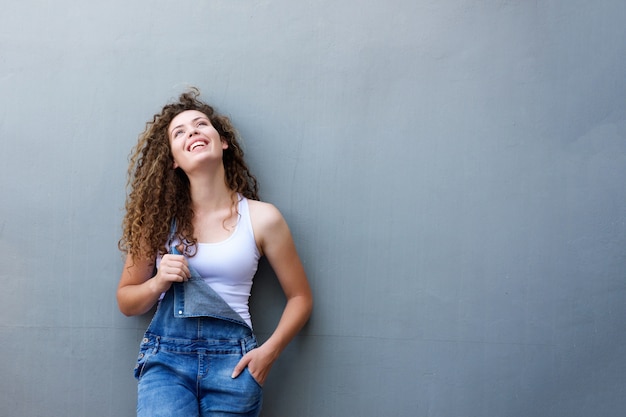 Trendy happy teen girl standing with hand in pocket