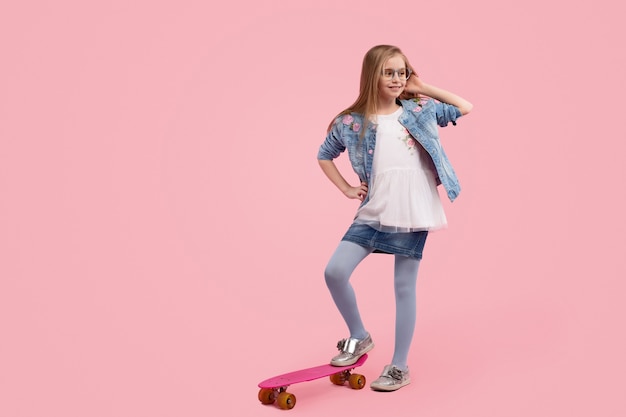 Trendy little girl against pink background