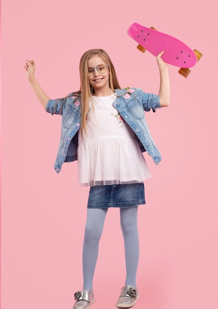 Trendy little girl against pink background