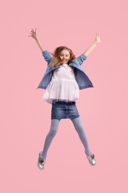 Trendy little girl against pink background