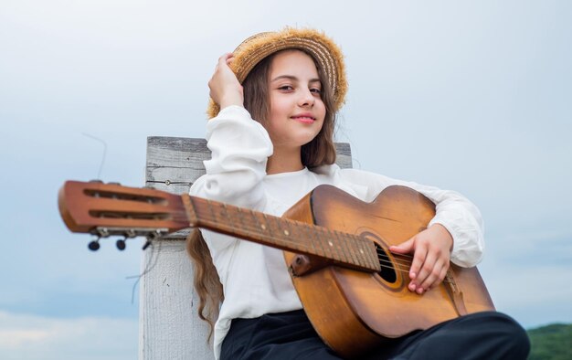 Trendy looking kid girl play acoustic guitar singer