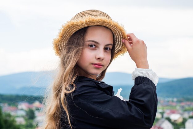 Trendy looking kid girl with pretty face outdoor happy childhood