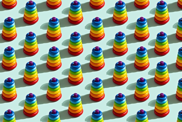 Trendy pattern of colorful toy pyramid on blue background, childhood concept