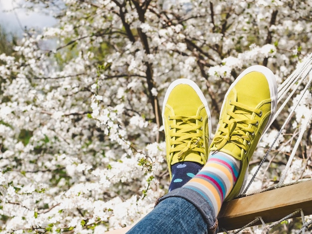 Trendy sneakers and colorful socks Closeup outdoors