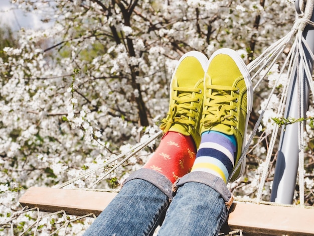 Trendy sneakers and colorful socks Closeup outdoors