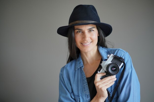  Trendy stunning brunette with vintage camera                                               