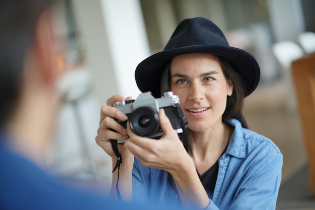  Trendy stunning brunette with vintage camera                                         