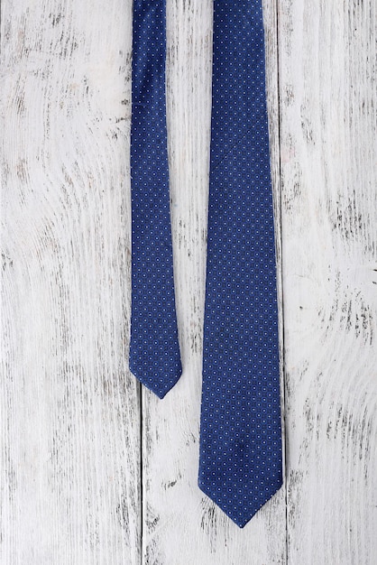 Trendy tie on color wooden background