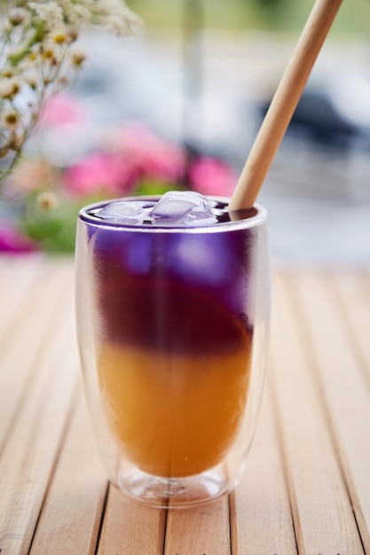 Trendy verfrissende blauwe en gele cocktail met anchan-blauwe thee-antioxidanten en detoxwater met ecologisch natuurlijk stro buiten Natuurlijke zomerdrank