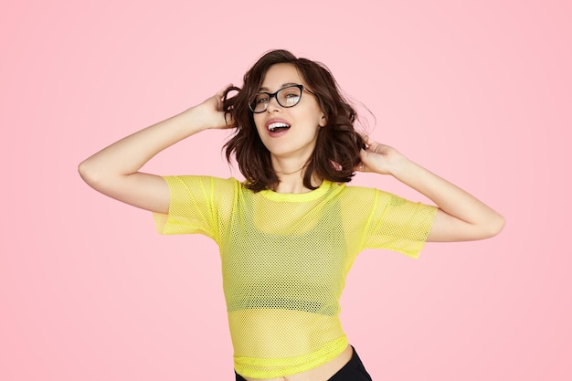 Trendy young female touching hair and smiling