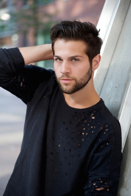 Trendy young man posing with hand in hair