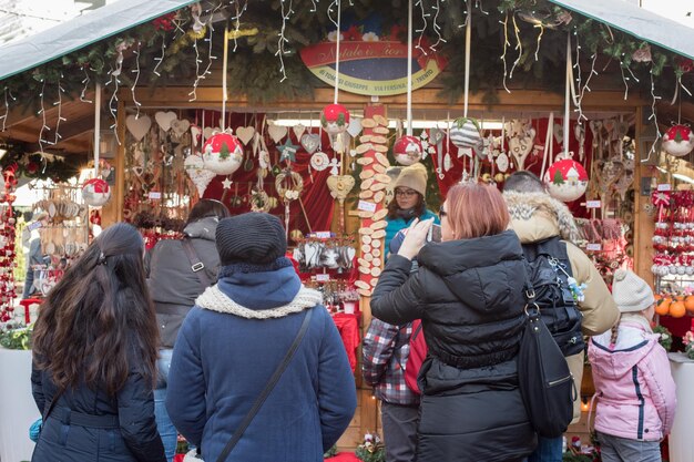 Photo trento, italy - december 1, 2015 - people at traditional xmas market