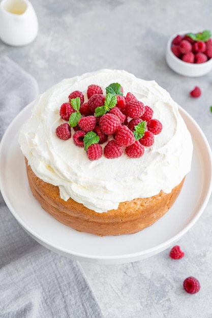 Tres leches cake with whipped cream and fresh raspberries on top Traditional cake from Latin America