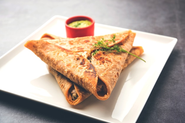 Triangle Paratha Wrap with potato chicken filling served with green chutney, Indian food