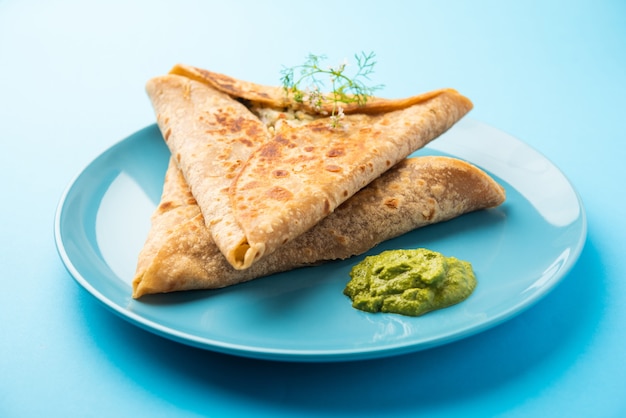 Triangle Paratha Wrap with potato chicken filling served with green chutney, Indian food