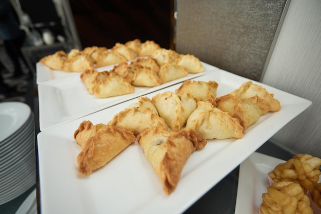 Triangular pies on a plate uchpochmak catering